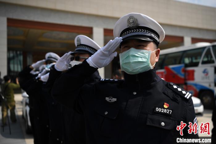圖為交警們向醫(yī)療隊(duì)敬禮?！】灯?攝